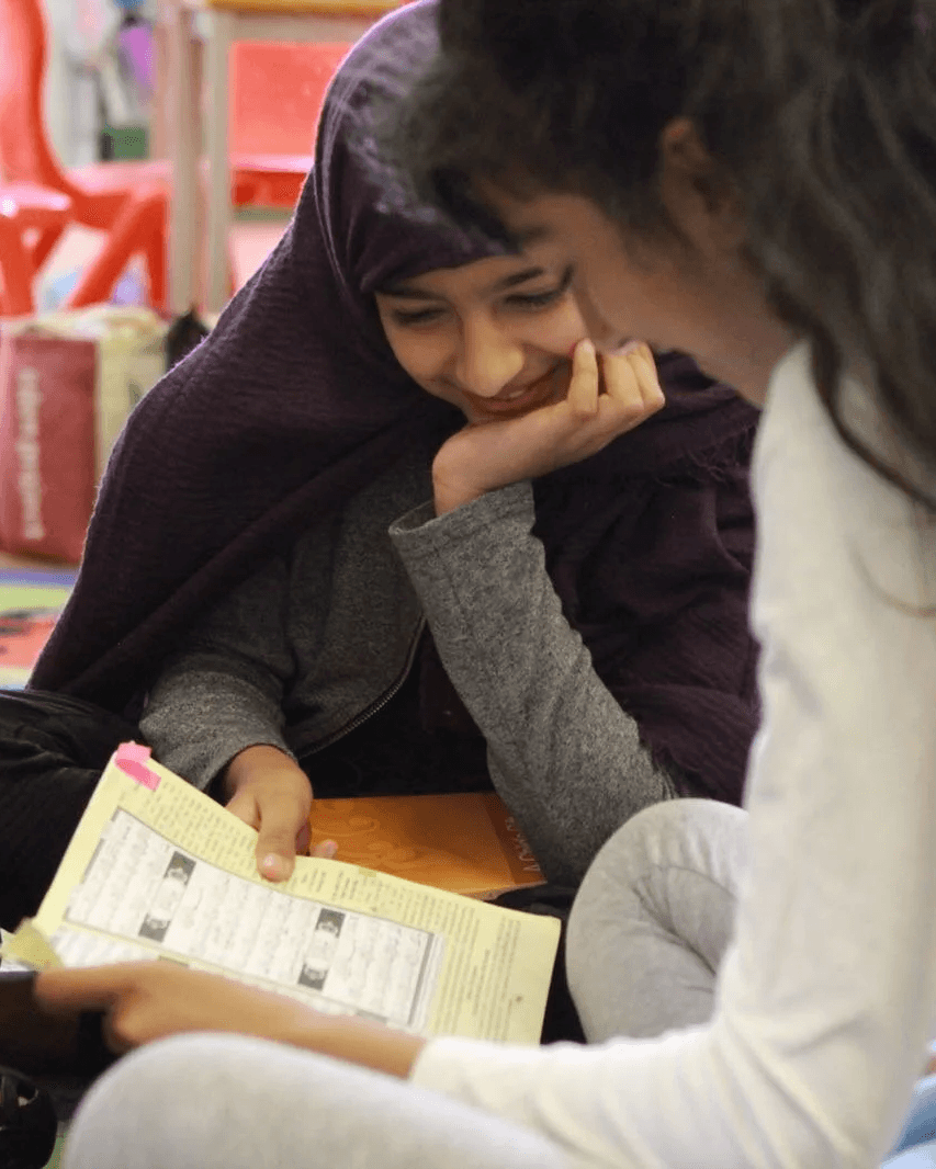 A teacher guiding a small group of children