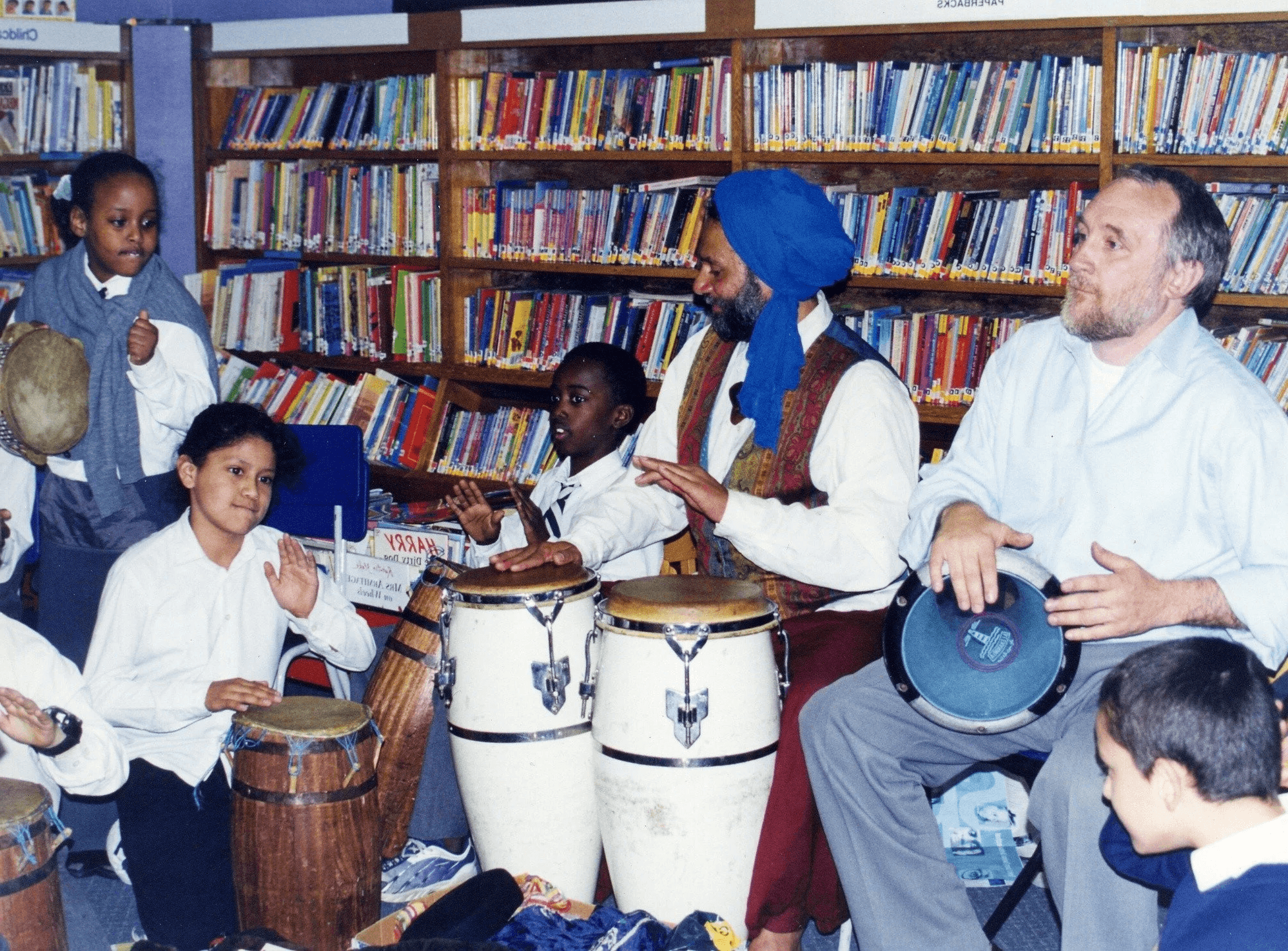 Children playing drums at an SMS workshop