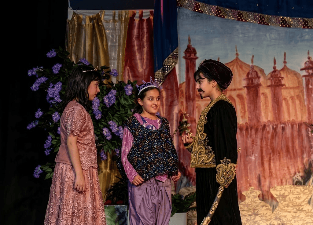 Pupils performing together at a school celebration