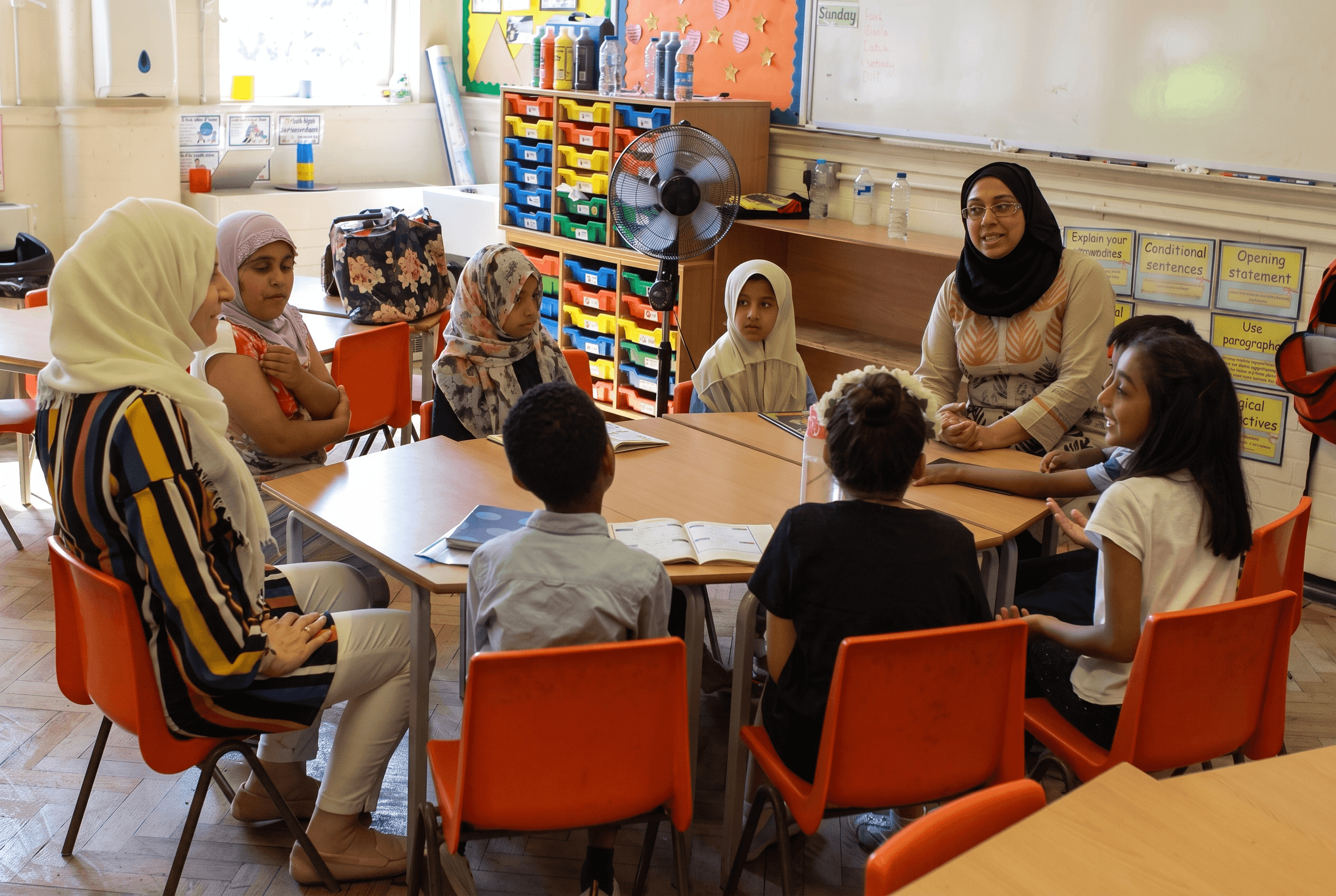 Children and teachers gathered for a classroom activity