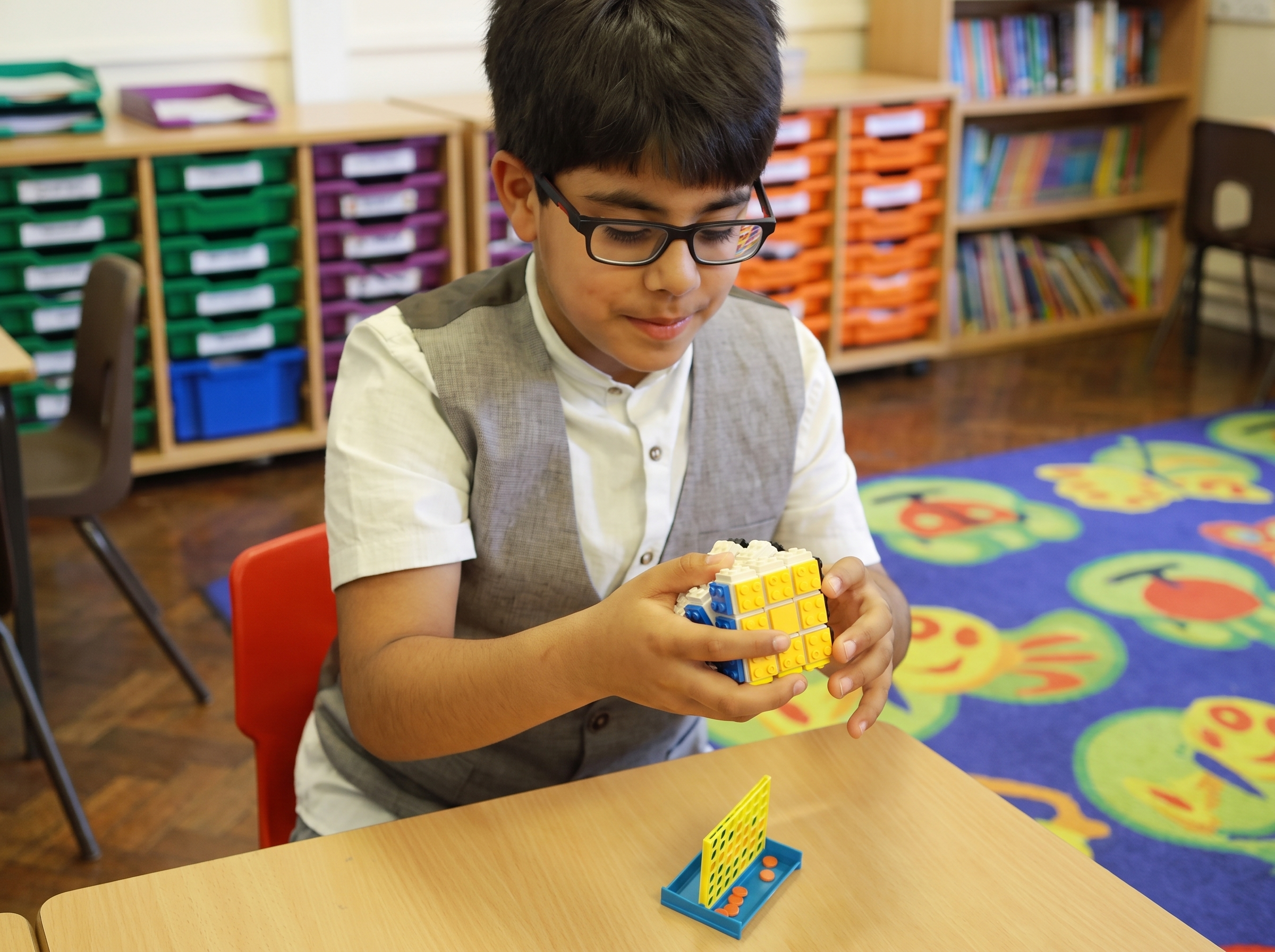 A pupil concentrating on a hands-on learning activity